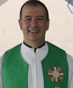 Pe. Leonel Stanski sorrindo, com veste litúrgica verde